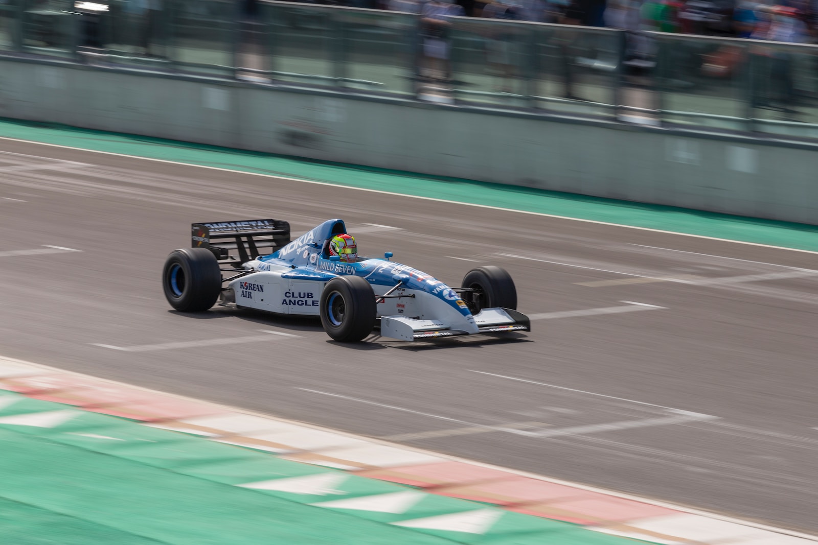blue and white f 1 car on track